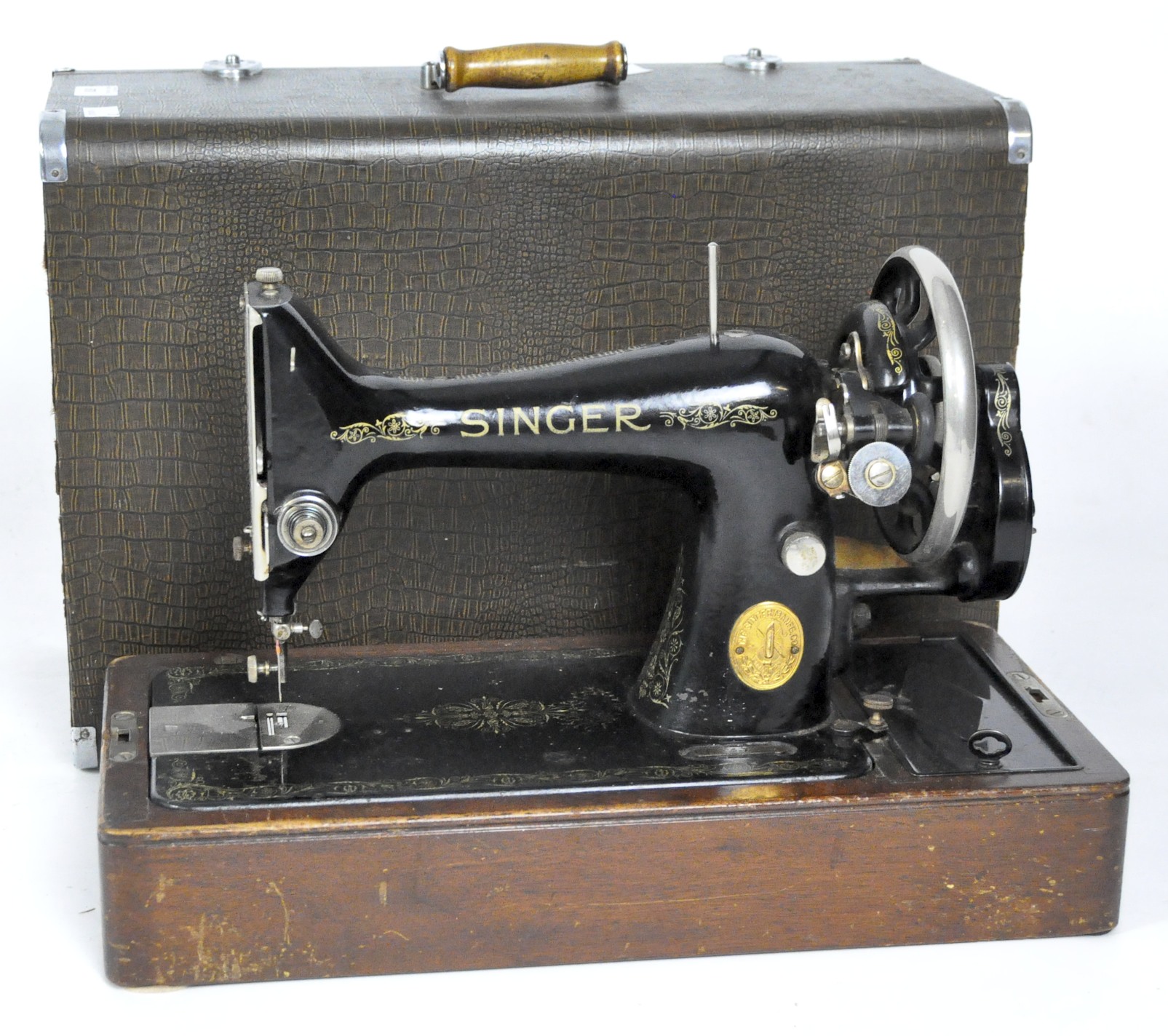 A vintage Singer sewing machine, painted in black with gilt embellishments,