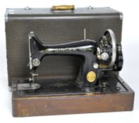 A vintage Singer sewing machine, painted in black with gilt embellishments,