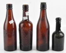 Four early 20th century glass bottles, two marked Lovibond & Sons and one Whitbread,