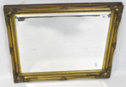 A reproduction bevelled edge wall mirror, of rectangular form,