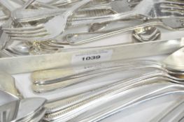 A selection of flatware, including a boxed set of stainless steel knives and forks, an EPNS ladle,