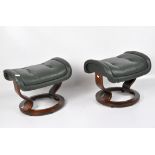 A pair of E Kormes vintage 'stressless' foot stools, with green upholstery,