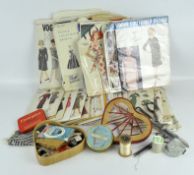 A quantity of vintage sewing patterns, from various designers including Vogue, with sewing equipment