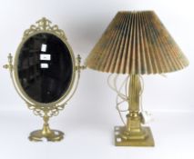 A brass columnal table lamp with shade together with a brass dressing table swing mirror