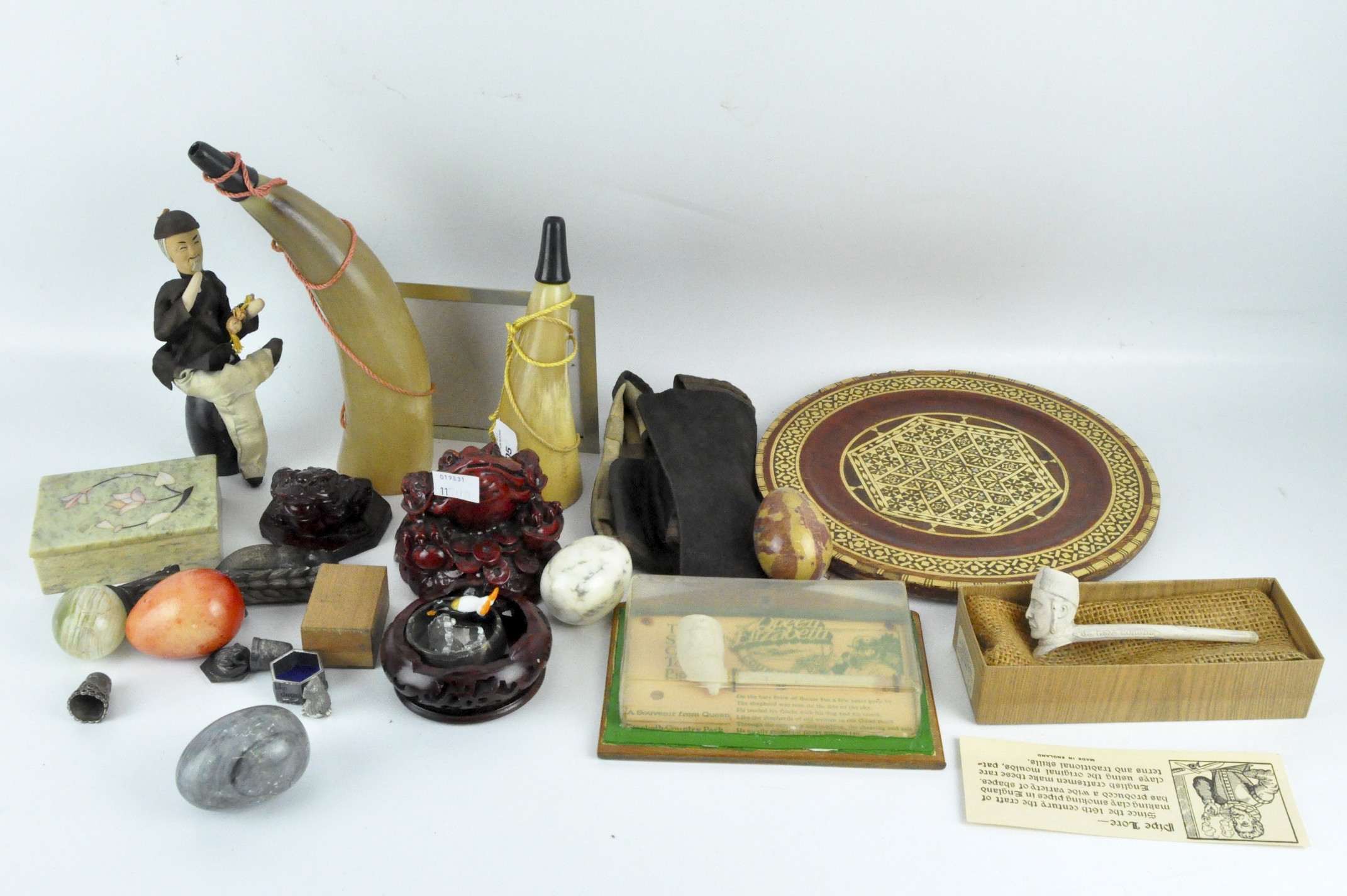 An assortment of collectables, including oriental carvings, a silver thimble,