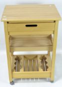 A contemporary wooden butlers trolley, incorporating a lower wine rack, an open shelf and a drawer,