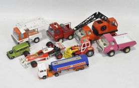 A collection of vintage tiplate and diecast toys, including a fire engine,