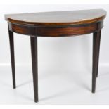 A 19th century demi-lune mahogany card table with inlaid edging, on square tapered supports,