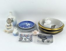 A collection of Royal Copenhagen ceramics, including floral vases, figures of birds and a child,