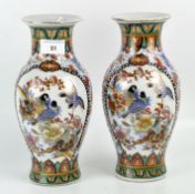 A pair of baluster vases with Chinese-style decoration of birds and flowering branches and gilt