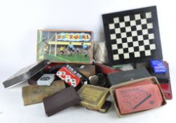 A group of vintage games, including a Dominoes set, chess set and pack of cards,