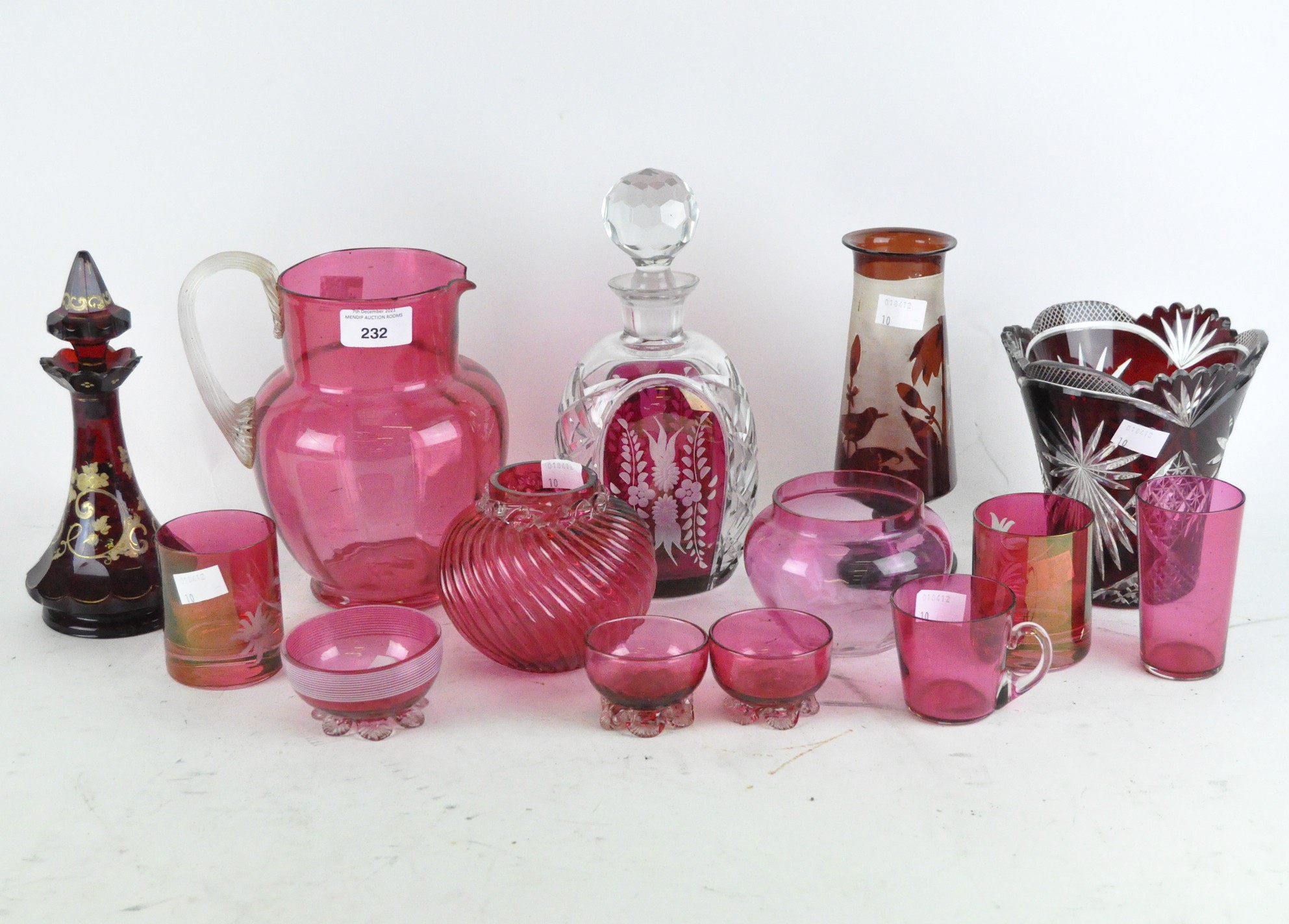 A collection of cranberry glass together with a 19th century flash glass decanter and vase