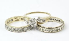 Three ladies 9ct gold rings, two being full eternities, set with small white stones,