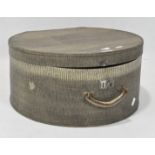 A vintage hat box, of circular form, with leatherette finish and a carry handle and lock,