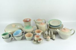 A collection of vintage Poole pottery including two part tea and coffee sets