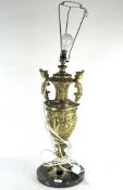 A large gilt ornate table lamp in the form of a twin handled urn,