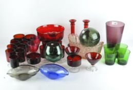 20th century coloured glassware, including a set of ten red glasses, pair of red candlesticks,
