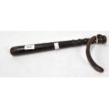 A reproduction stained pine police truncheon, with a leather strap to one end, length 38cm.