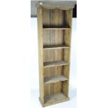 A early 20th century stained pine bookcase, eight fixed shelves on a pediment base,