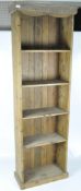 A early 20th century stained pine bookcase, eight fixed shelves on a pediment base,