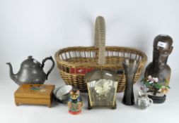 A variety of collectables, including a set of Russian dolls, carved wooden sculpture, wicker basket,