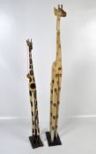 Two contemporary carved wooden giraffe figures, on rectangular bases,