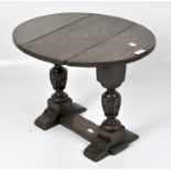 A Victorian small drop leaf table, of oval form, turned supports with a single stretcher,