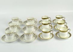 Two sets of six coffee cups and saucers with gilt and dark blue decoration, one Kennards Croydon,