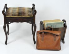 An upholstered piano stool together with a newspaper rack, satchell and sheet music