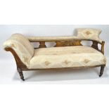 An early 20th century mahogany chaise lounge, with open work supports, turned legs,