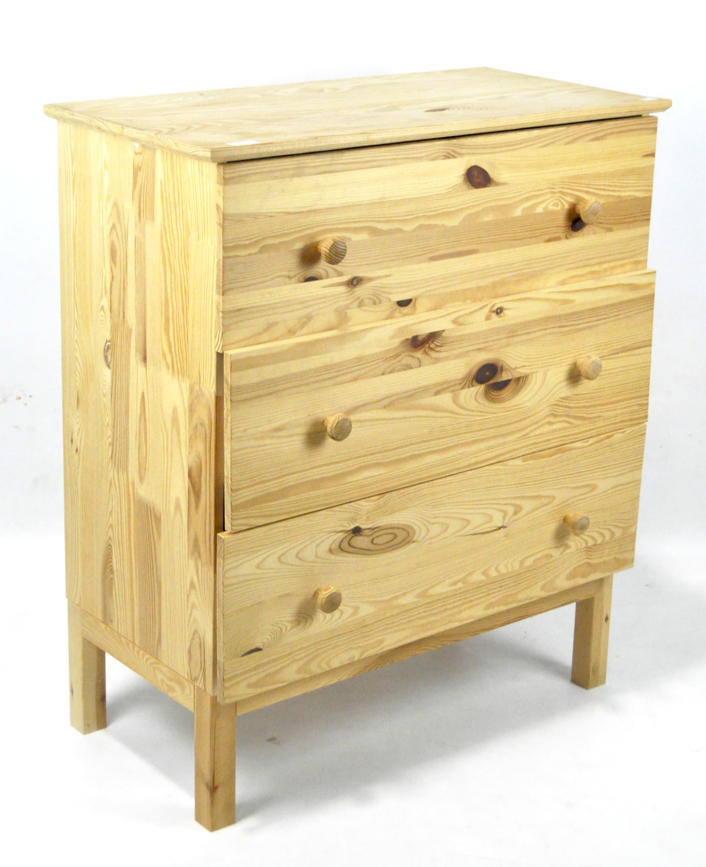 A contemporary pine chest of drawers, comprising three long drawers, raised on squared supports,