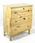 A contemporary pine chest of drawers, comprising three long drawers, raised on squared supports,