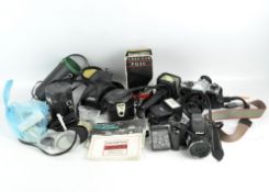 Assorted cameras including Nikon Coolpix P100, a Yashica FX-D Quartz, various lenses and flashes,