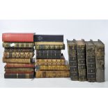 A collection of antique books, mostly leather bound,
