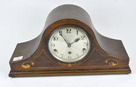 A Napoleon hat mantle clock, the silvered dial with Arabic numerals,