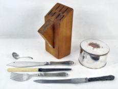 A round plated biscuit box with hinged lid together with some flatware and a wood knife block