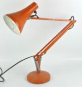 A vintage orange anglepoise style lamp,