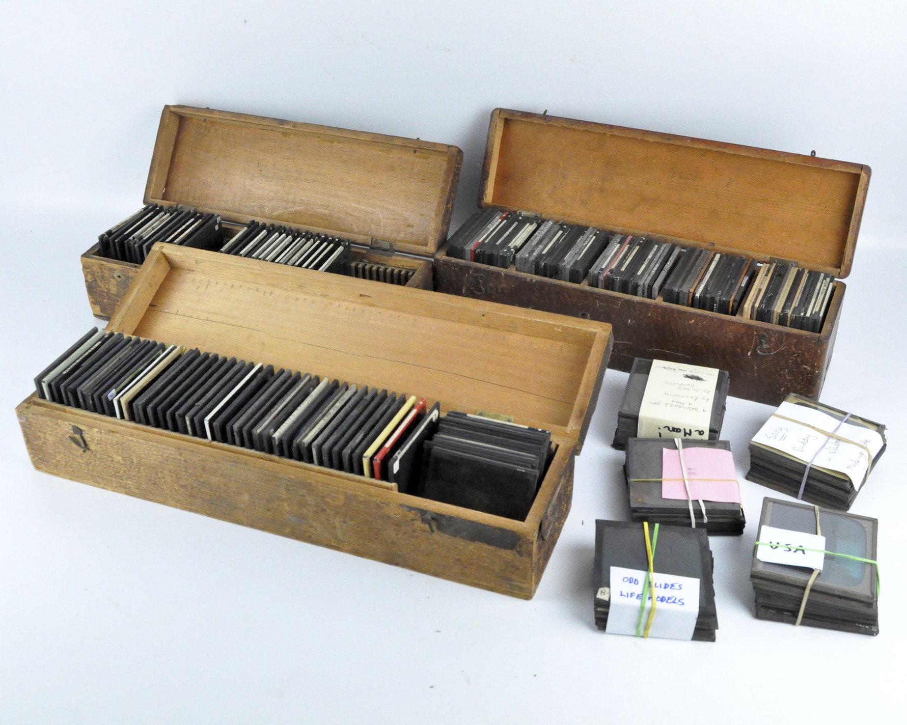 Three vintage wooden boxes of magic lantern slides: topographical, cathedrals, adverts,