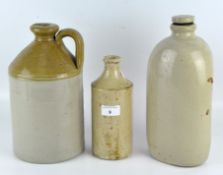 Three stoneware flagons, largest with loop handle with honey and beigecoloured-glaze, height 27cm,