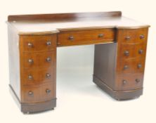 A 19th century mahogany desk, a long drawer to the centre with four drawers to either side,