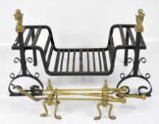 A set of brass fire irons, together with a cast metal fire grate with scroll feet and brass details,