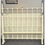 A 20th century cast metal bedframe, painted white with moulded floral decoration and metal finials,
