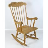 A 20th century wooden rocking chair, with spindle back and turned supports,