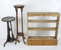 Two wooden jardiniere stands, both with circular tops, together with a rustic pine bookshelf