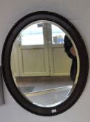 A late 19th/early 20th century bevelled edge wall mirror, of oval form, 60cm x 49cm.