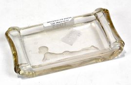 A glass ashtray etched and cut with a scene of a small boy blowing bubbles from a pipe, width 13cm.