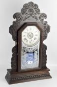 A vintage Ansonia USA clock, the white face displaying Roman numerals,