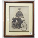 A WWI print of a dispatch rider with bicycle, 39cm x 31cm,