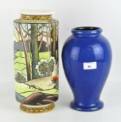 Two vases: of cylindrical form, polychrome decorated with a farmer tending a bonfire under trees,