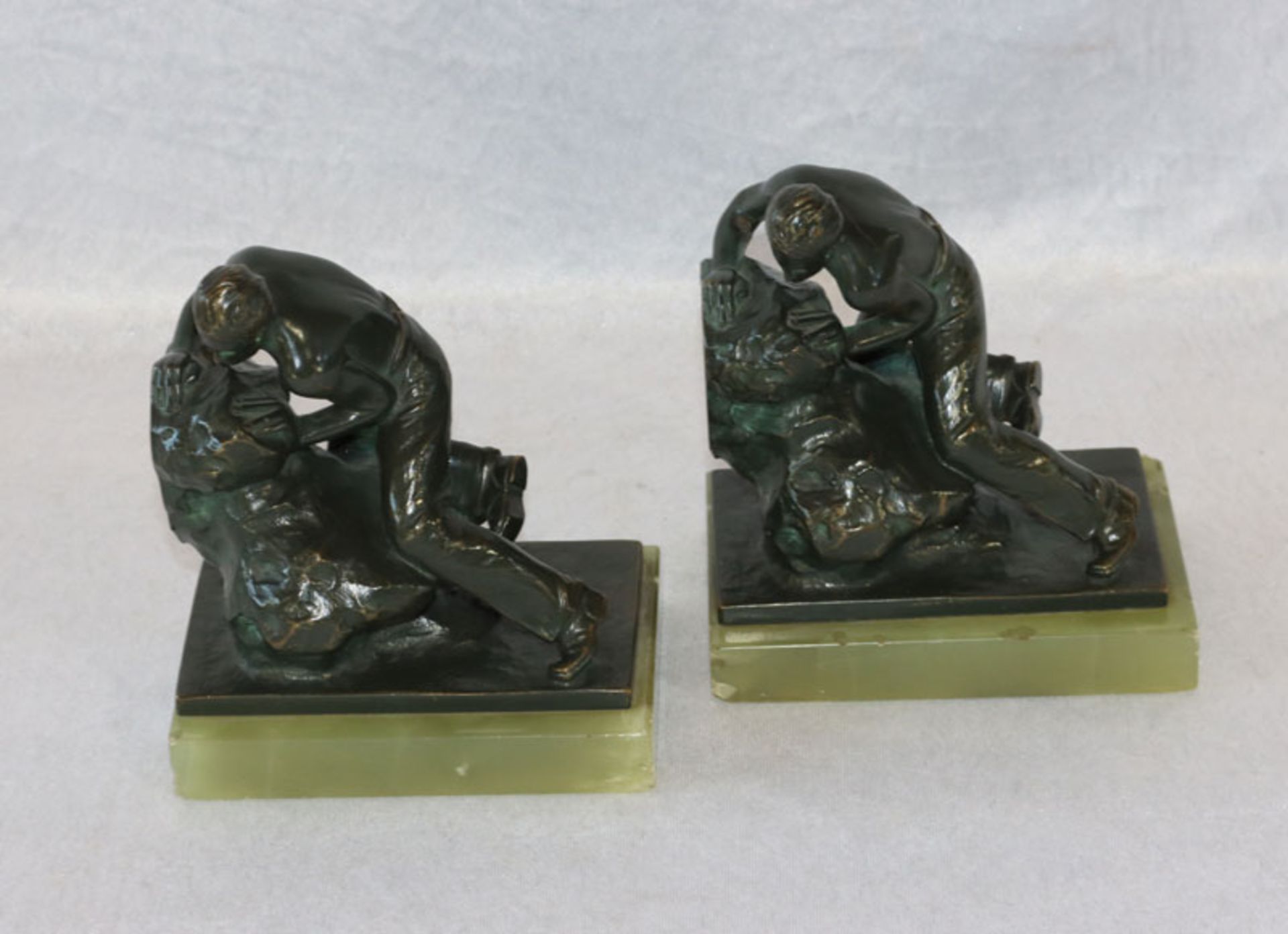 Paar Buchstützen, 'Mann am Fels', Bronze patiniert auf grünem Marmor, signiert Zach, wohl Bruno Zach